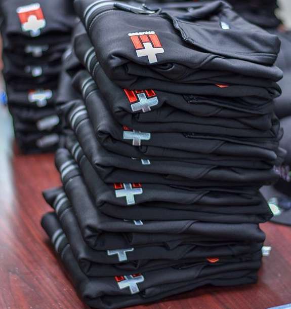 Stack of folded black branded work shirts