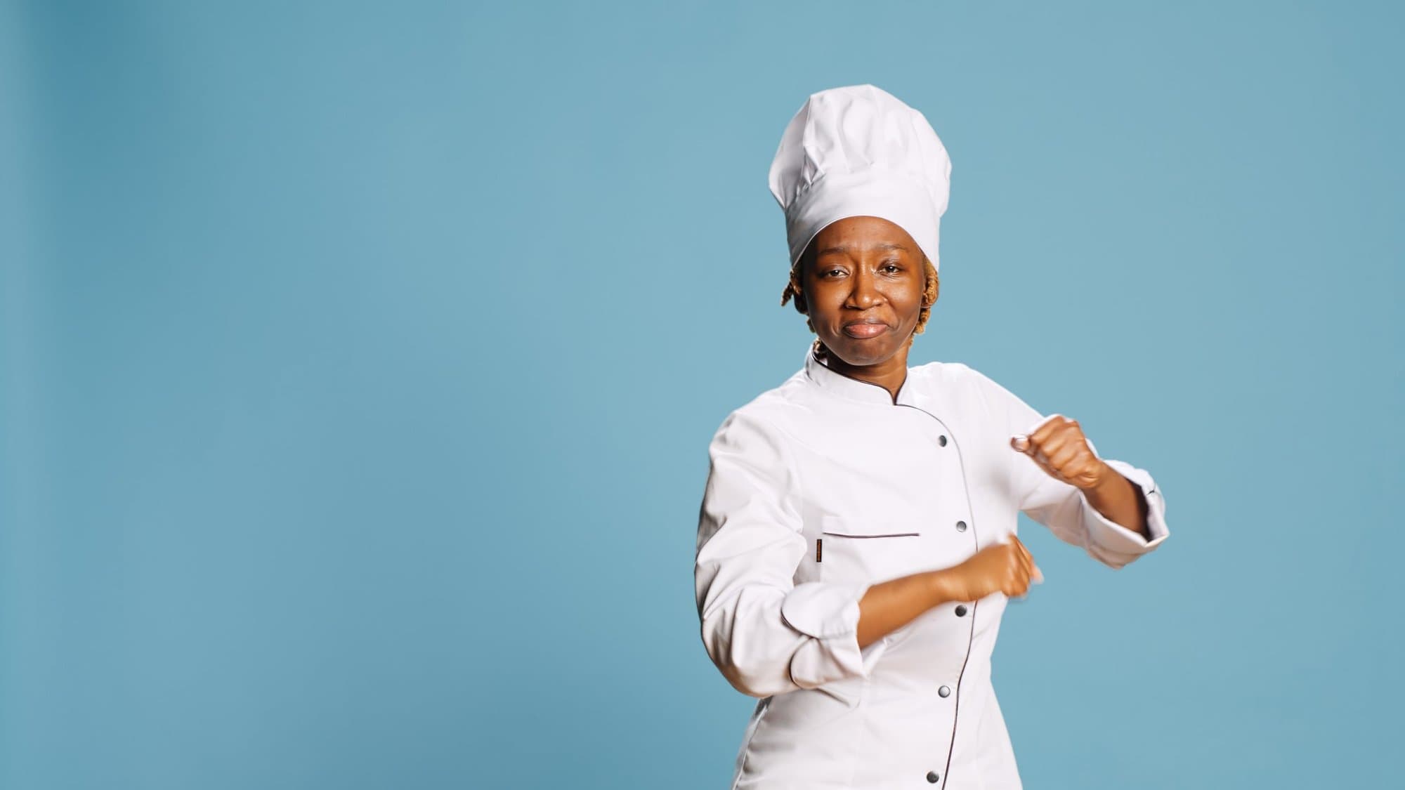 Chef in a white double-breasted jacket and tall chef's hat