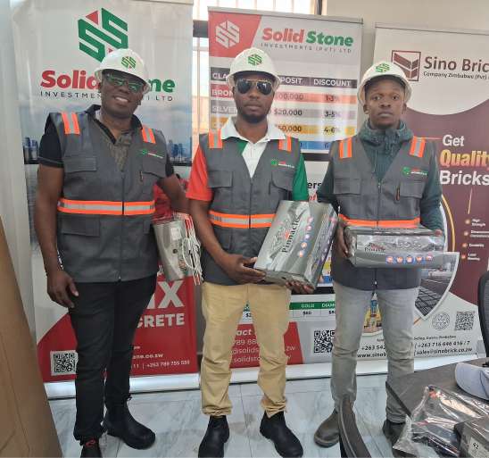 Three men in grey reflective vests with orange tape holding branded packs