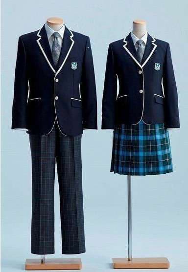 Navy school blazers with white piping over checked trousers and a tartan skirt on mannequins